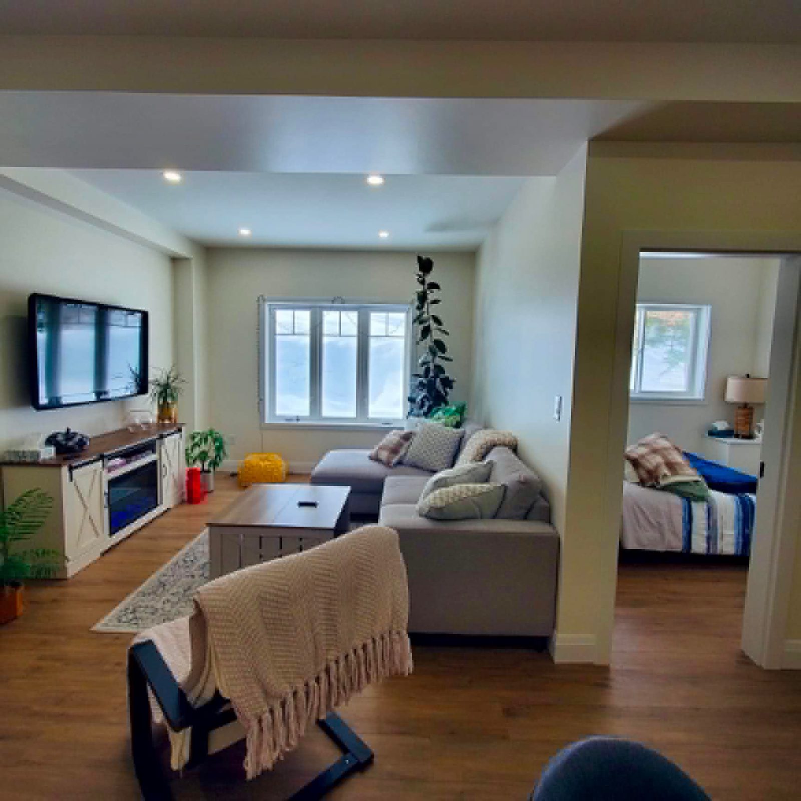 Basement living room view by ARK Renovation