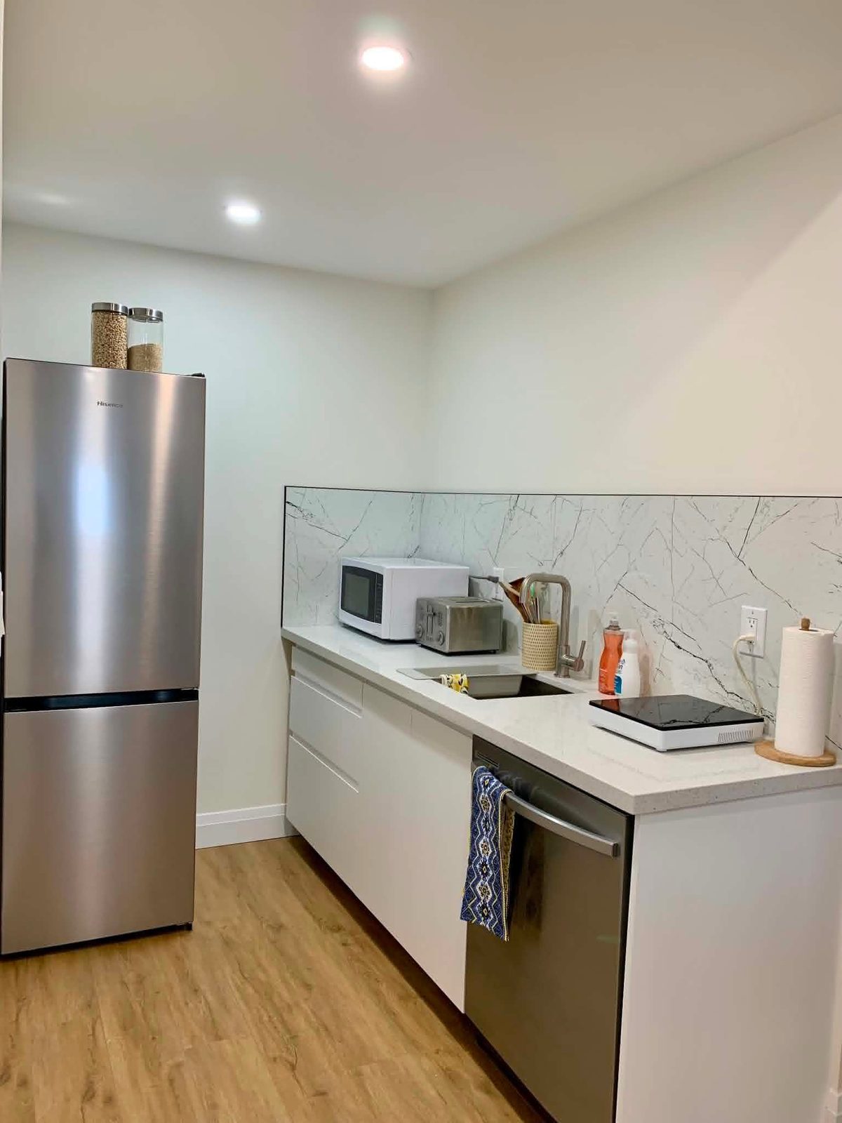 Basement kitchenette with dishwasher installed by ARK Renovation